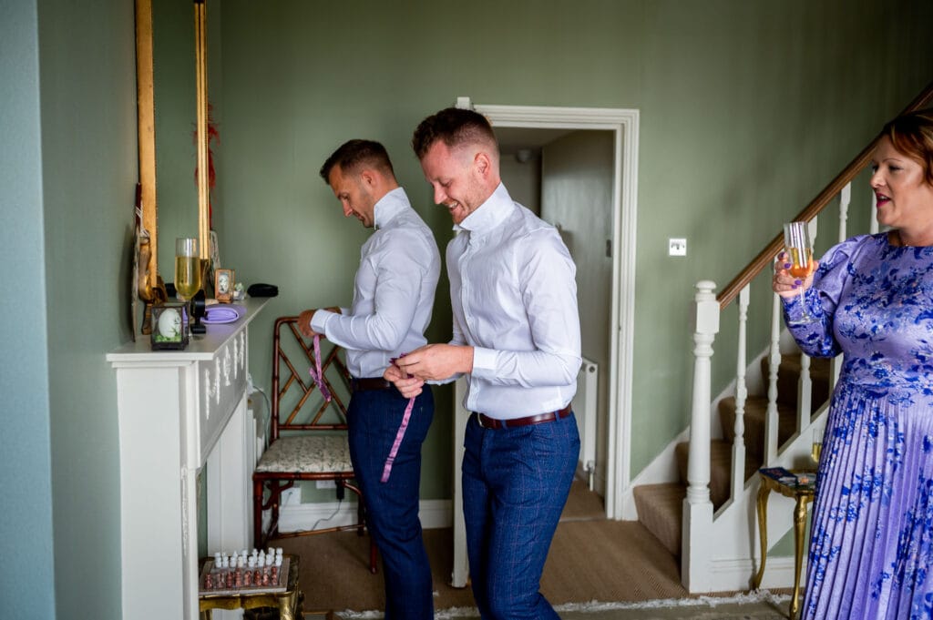 two grooms getting dressed for their Brighton Wedding