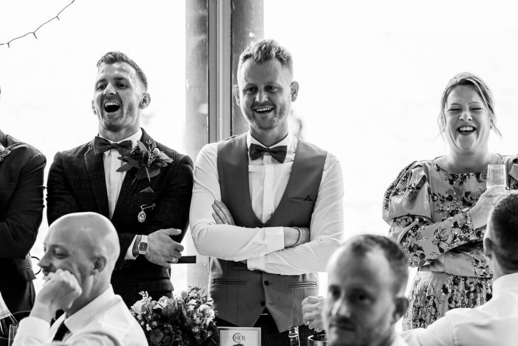 two grooms laughing during speeches at their Seahorse Brighton Wedding